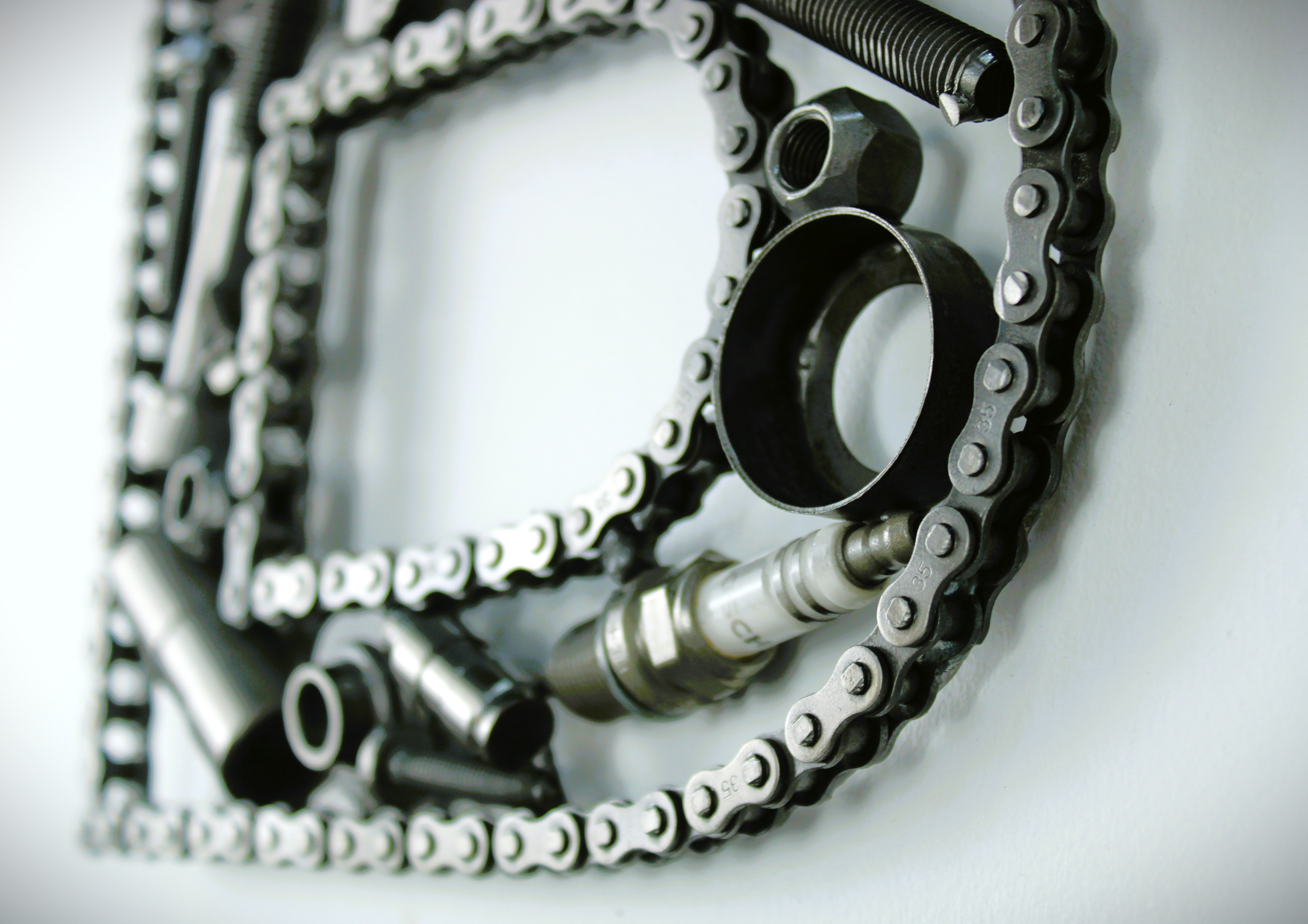 Metallic gear and chain design on a white background