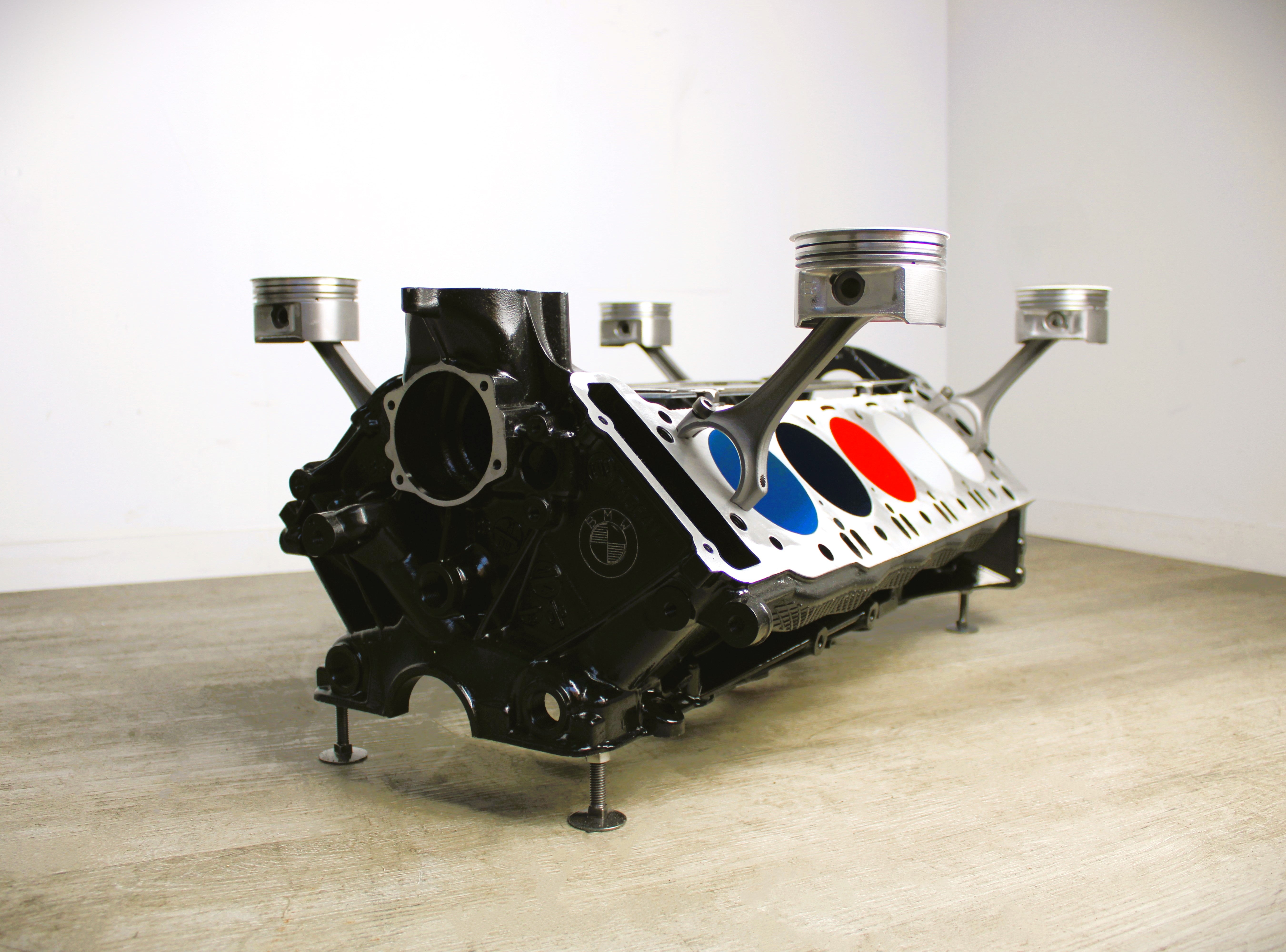 BMW M Series V10 engine block coffee table painted in the BMW M-Power color scheme without its glass top.