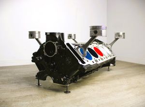 BMW M Series V10 engine block coffee table painted in the BMW M-Power color scheme without its glass top.