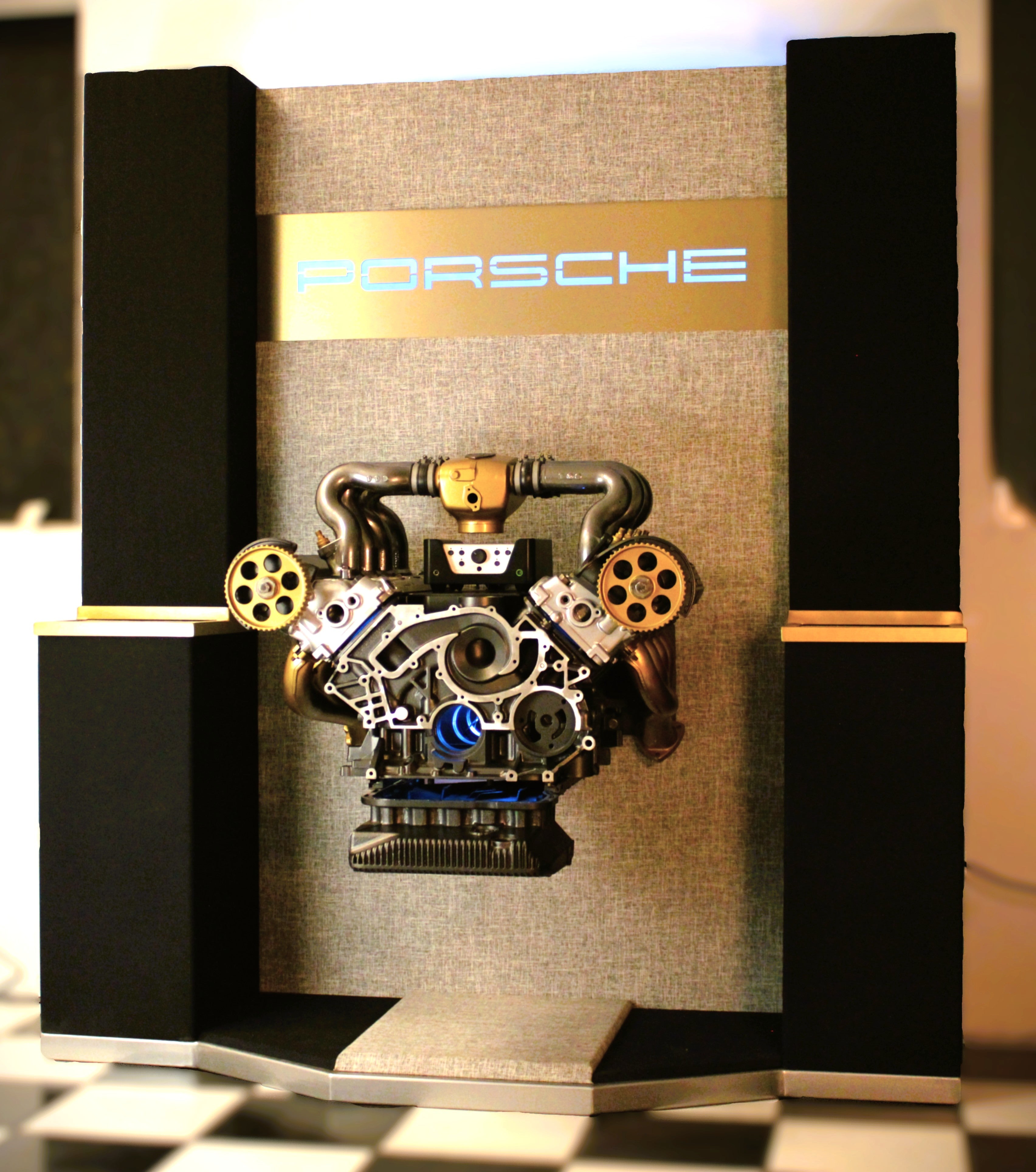 Porsche 928 engine suspended between custom speaker towers