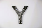 Load image into Gallery viewer, A letter Y made out of real car parts, outlined with a timing chain.
