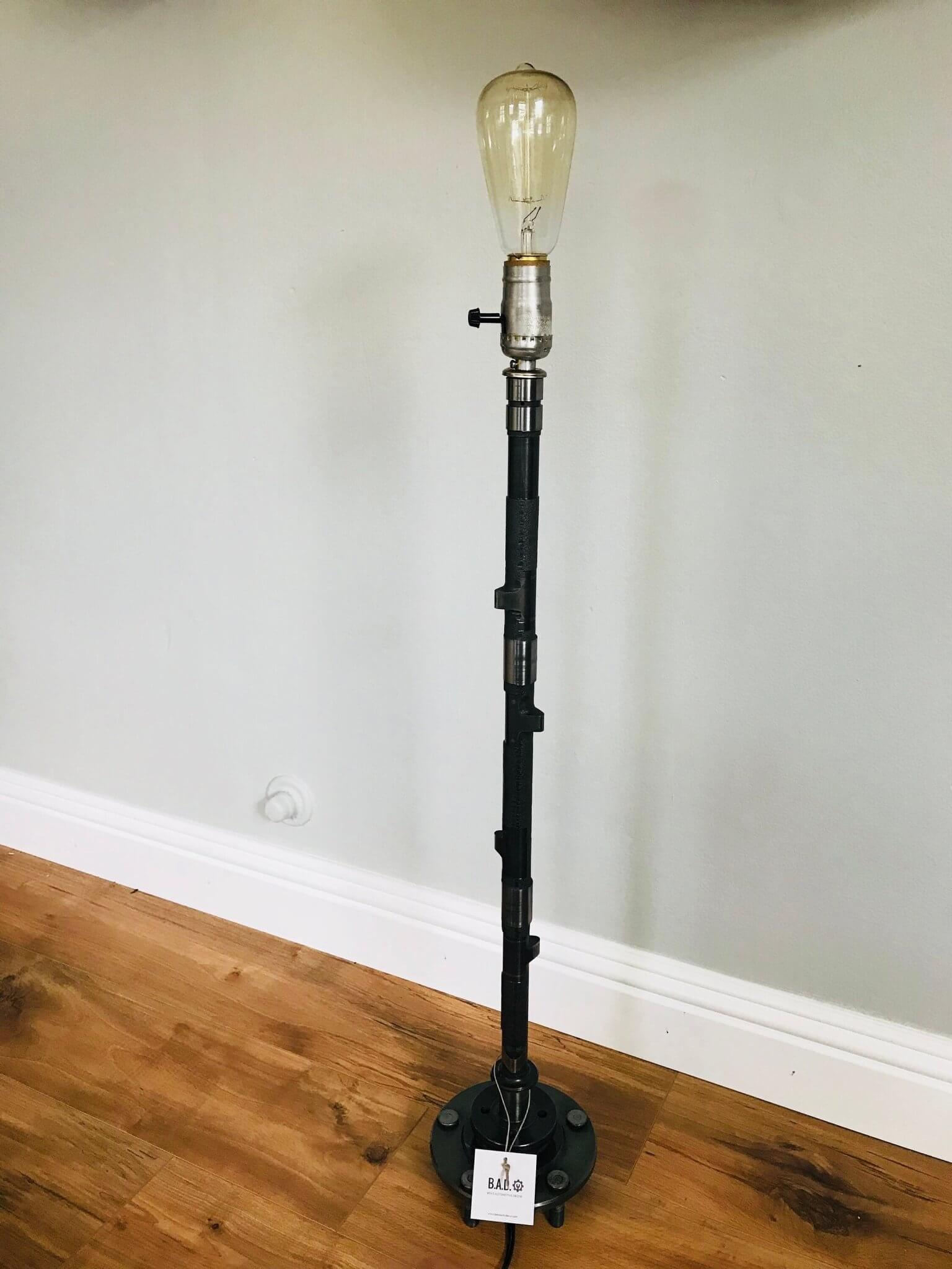 Tabletop lamp handcrafted from a genuine polished car engine camshaft with a LED lightbulb.