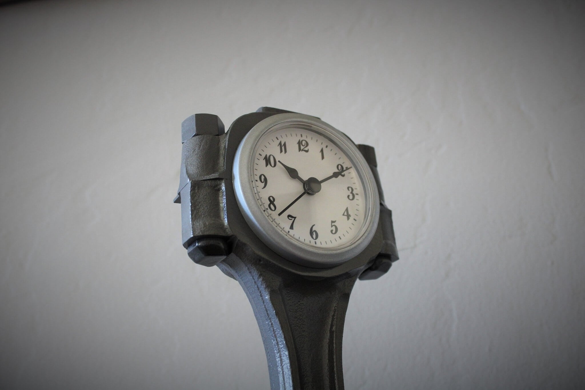 Tabletop clock handcrafted from a genuine Chevrolet car engine piston with various colored finishes and a standard clock face.