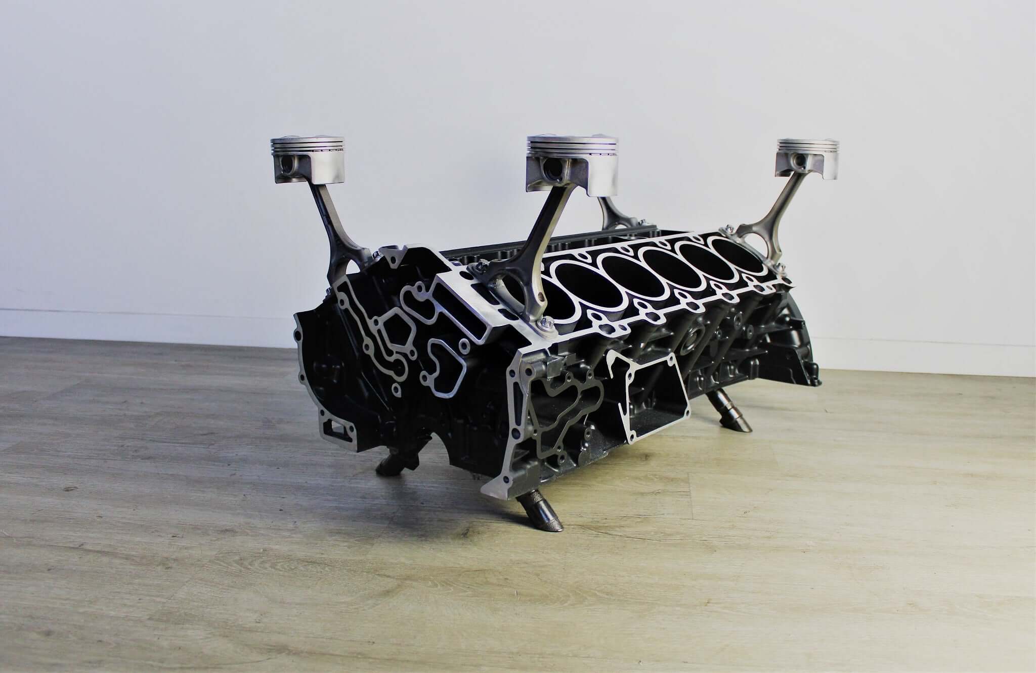 Coffee table handcrafted from a genuine Mercedes V12 car engine, finished in black and silver with the Mercedes-Benz logo displayed and a rectangular glass top.