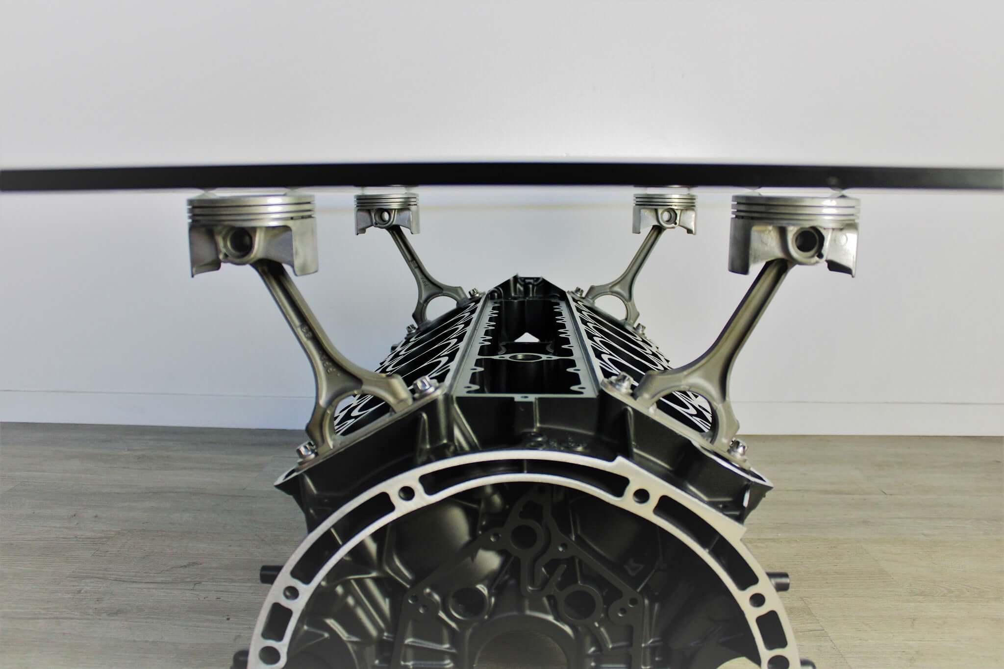 Coffee table handcrafted from a genuine Mercedes V12 car engine, finished in black and silver with the Mercedes-Benz logo displayed and a rectangular glass top.