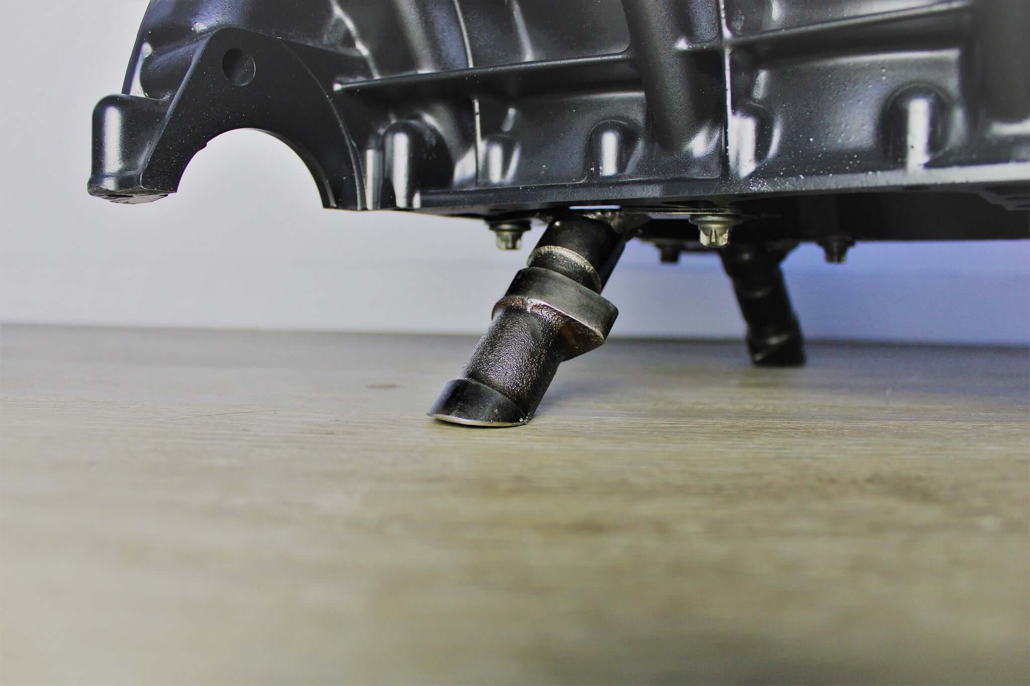 Coffee table handcrafted from a genuine Mercedes V12 car engine, finished in black and silver with the Mercedes-Benz logo displayed and a rectangular glass top.