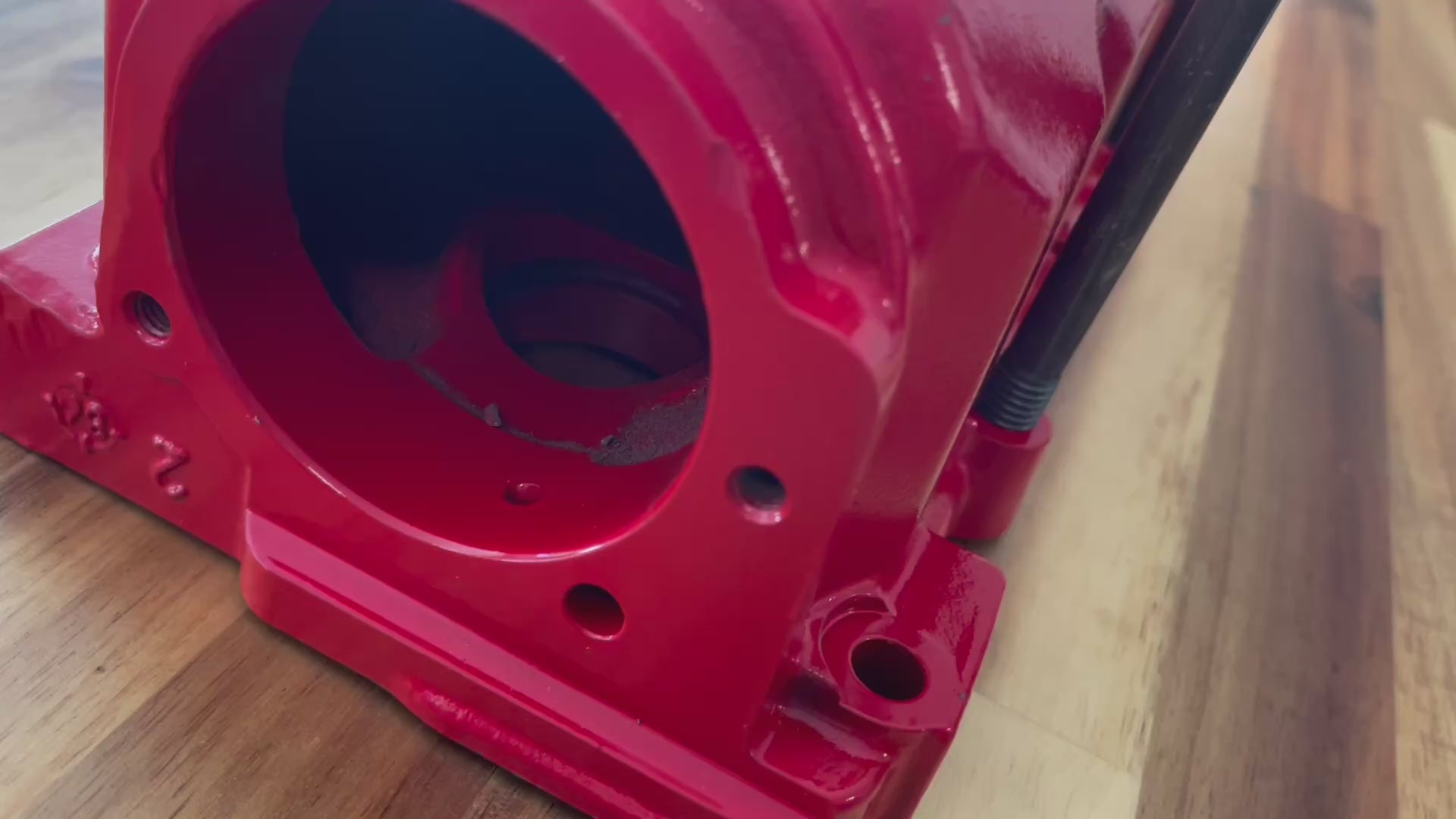 Video of a red and silver wall rack displaying the Porsche logo made from a Porsche intake manifold.