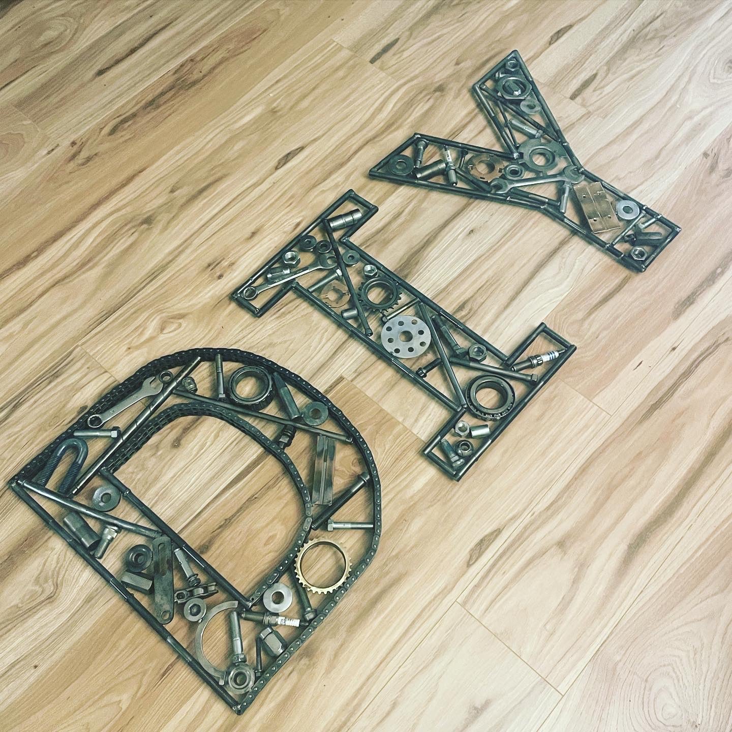 The letters DIY made out of real car parts.