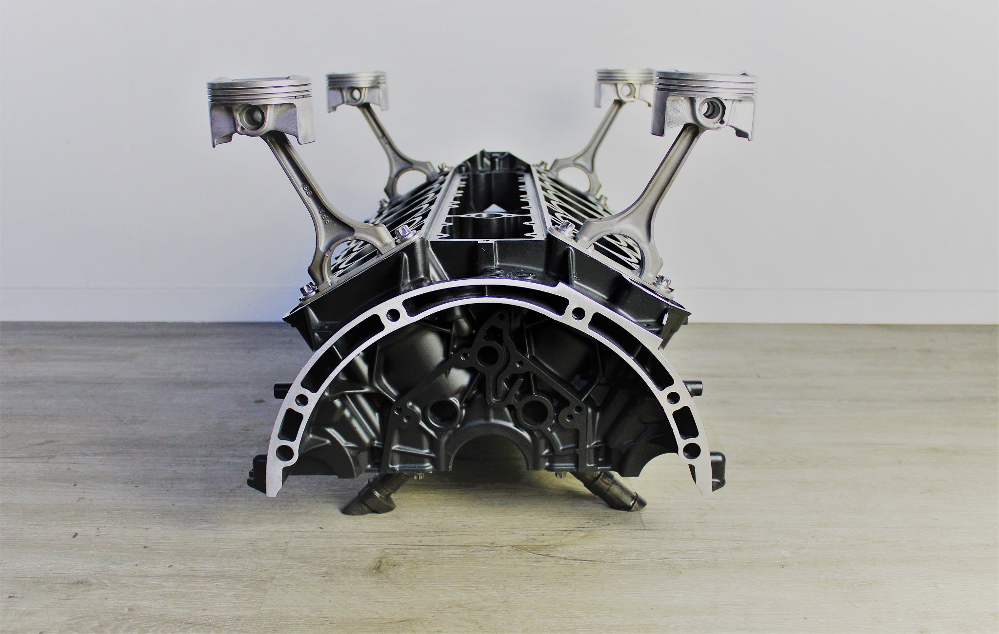 Mercedes V12 engine block coffee table, finished in black and silver without its glass top.