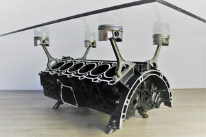 Mercedes V12 engine block coffee table, finished in black and silver with a rectangular glass top.