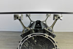 Load image into Gallery viewer, Close-up view of a Mercedes V12 engine block coffee table, finished in black and silver with a rectangular glass top.
