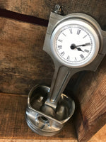 Load image into Gallery viewer, Clock made out of a car engine&#39;s piston, finished in gunmetal gray with a silver clock ring.
