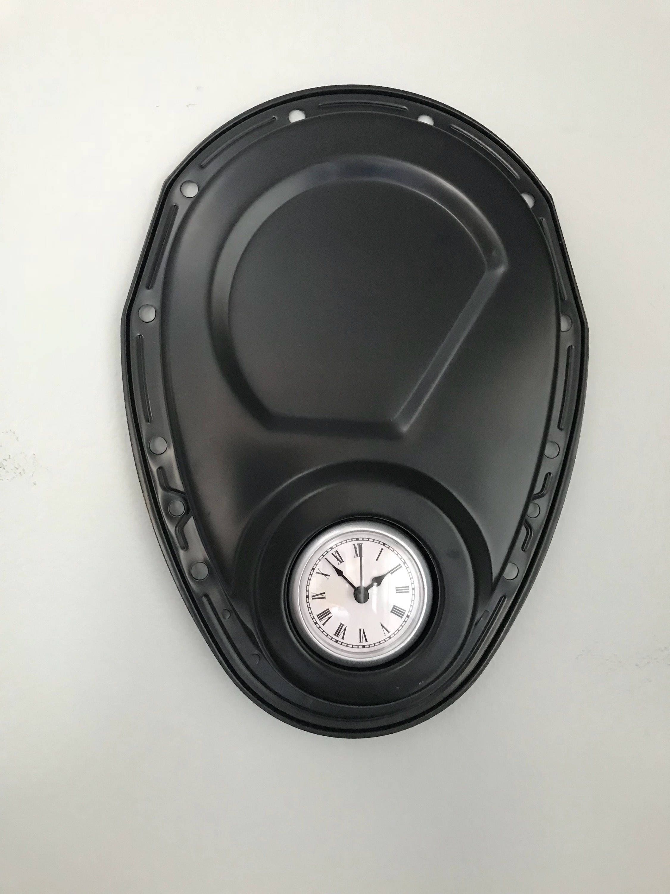 Clock made from a Chevrolet timing cover, finished in matte black.