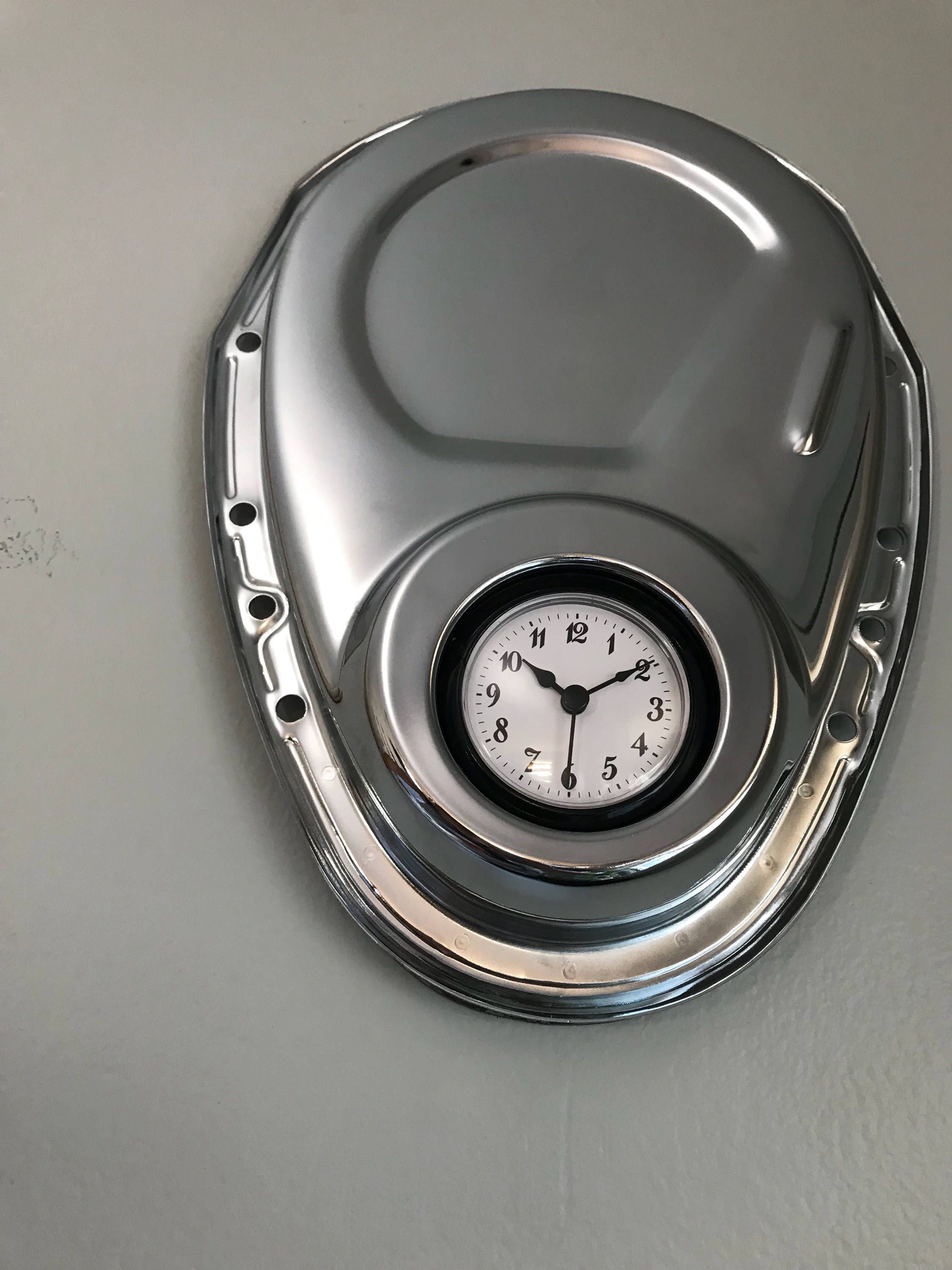 Clock made from a Chevrolet timing cover, finished in silver.