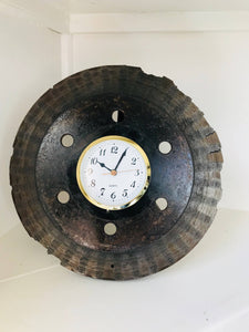 Desk clock made out of a car's brake disk in a patina finish with a gold clock ring.