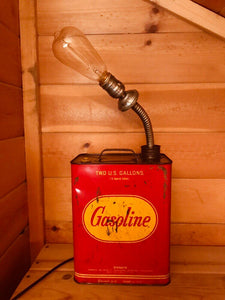 Lamp made out of a red and yellow vintage gas can with an incandescent lightbulb.