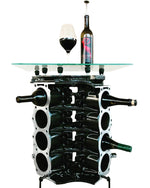 Load image into Gallery viewer, Engine block wine rack finished in black with a square glass top, wine bottles stored in its side and a wine bottle and glass on top.
