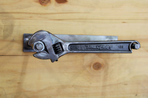 Wrench and nut toilet paper holder, finished in gunmetal gray.