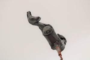 Close-up view of a bottle opener made out of a connecting rod corkscrew from a blown car engine.