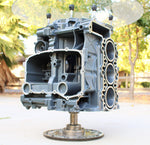 Load image into Gallery viewer, Porsche engine wine rack with a round glass top and finished in gray.
