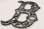 Load image into Gallery viewer, A letter B made out of real car parts, outlined with a car&#39;s timing chain.
