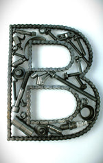 Load image into Gallery viewer, A letter B made out of real car parts, outlined with a timing chain.
