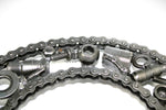 Load image into Gallery viewer, Close-up view of a letter C made out of real car parts, outlined with a timing chain.

