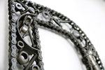 Load image into Gallery viewer, Close-up view of a letter D made out of real car parts, outlined with a timing chain.
