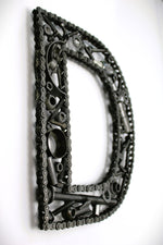 Load image into Gallery viewer, A letter D made out of real car parts, outlined with a timing chain.
