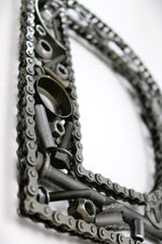 Load image into Gallery viewer, Close-up view of a letter D made out of real car parts, outlined with a timing chain.

