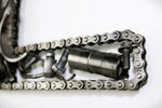 Load image into Gallery viewer, Close-up view of a letter E made out of real car parts, outlined with a timing chain.
