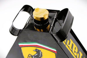Close-up of the cap of a black and yellow painted gas can with the Ferrari logo displayed.