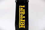 Load image into Gallery viewer, Side view of a black and yellow painted gas can with the Ferrari logo displayed.
