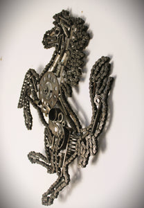 Side view of a Ferrari prancing horse logo art piece, made out of car parts and outlined with a timing chain.