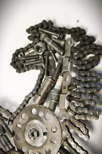 Load image into Gallery viewer, Close-up view of a Ferrari prancing horse logo art piece, made out of car parts and outlined with a timing chain.
