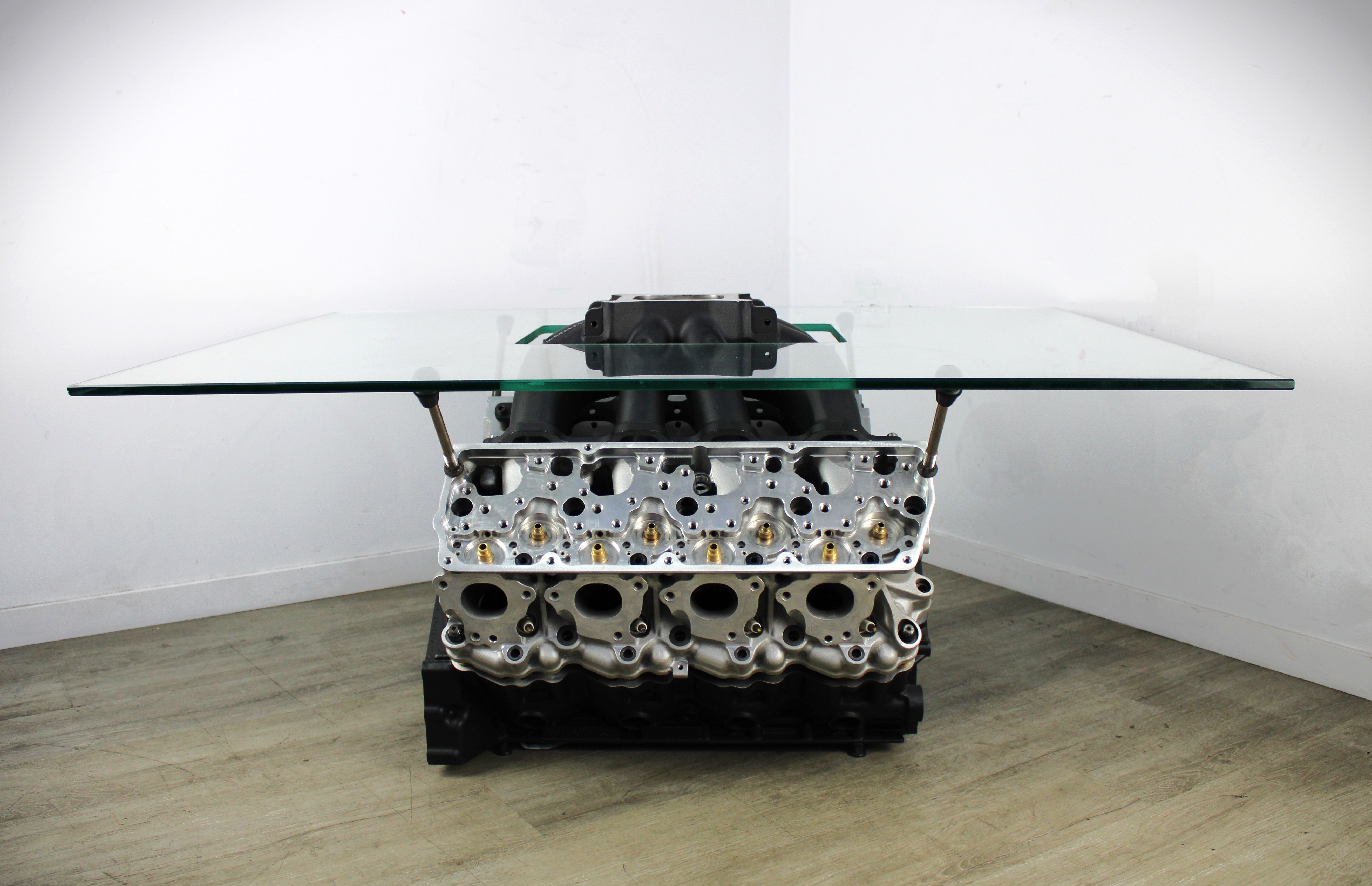 Ford FR9 engine block coffee table with a square glass top, finished in black and silver.