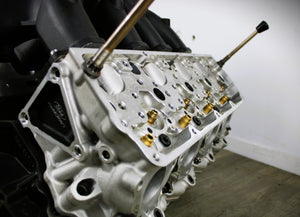 Close-up view of a Ford FR9 engine block coffee table, finished in black and silver.