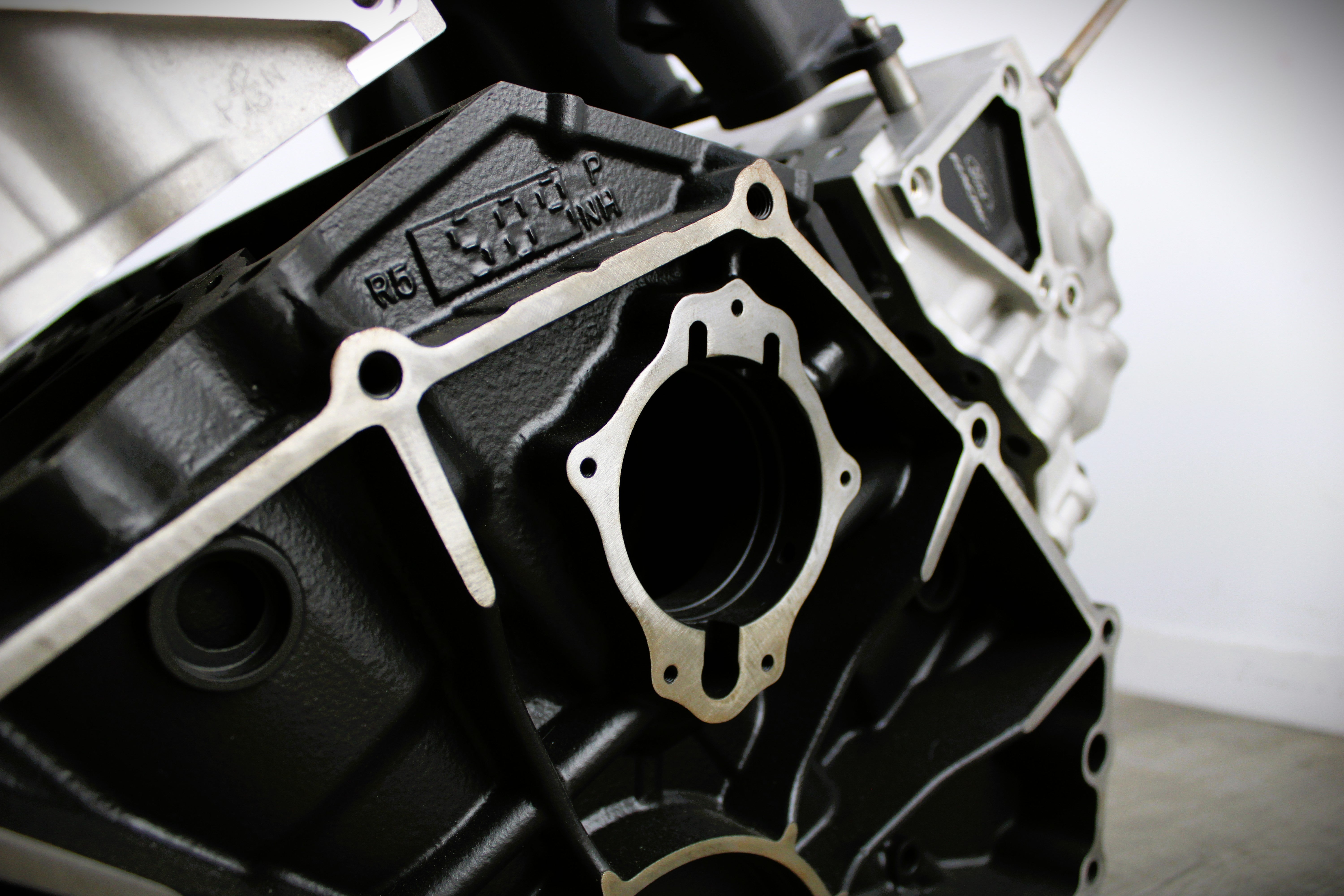Close-up view of a Ford FR9 engine block coffee table, finished in black and silver.