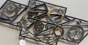 Chevrolet logo art made entirely out of real car parts, outlined with timing chain.
