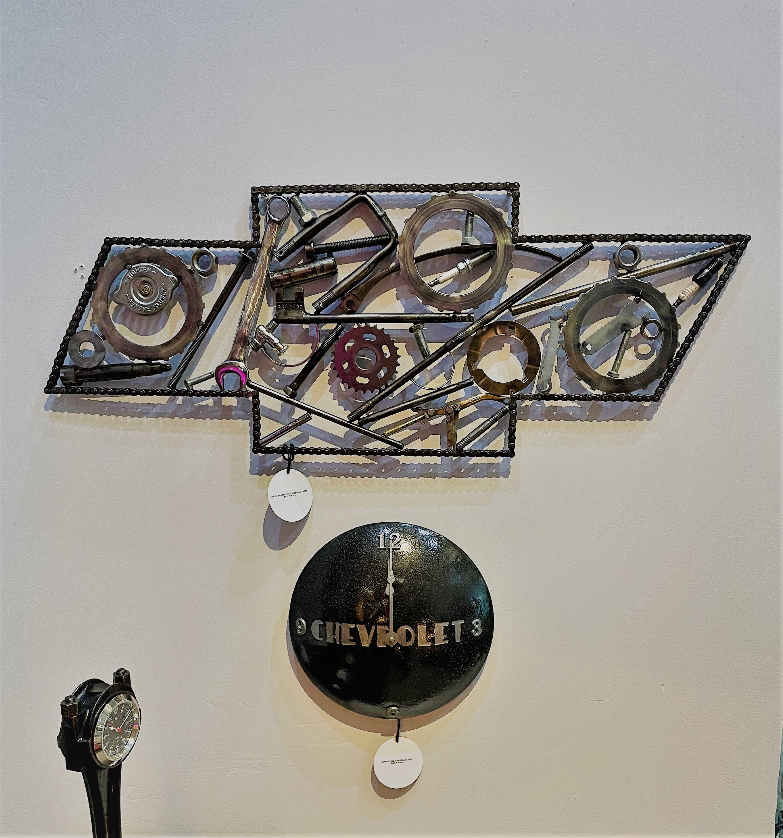 Chevrolet logo art made entirely out of real car parts, outlined with timing chain.