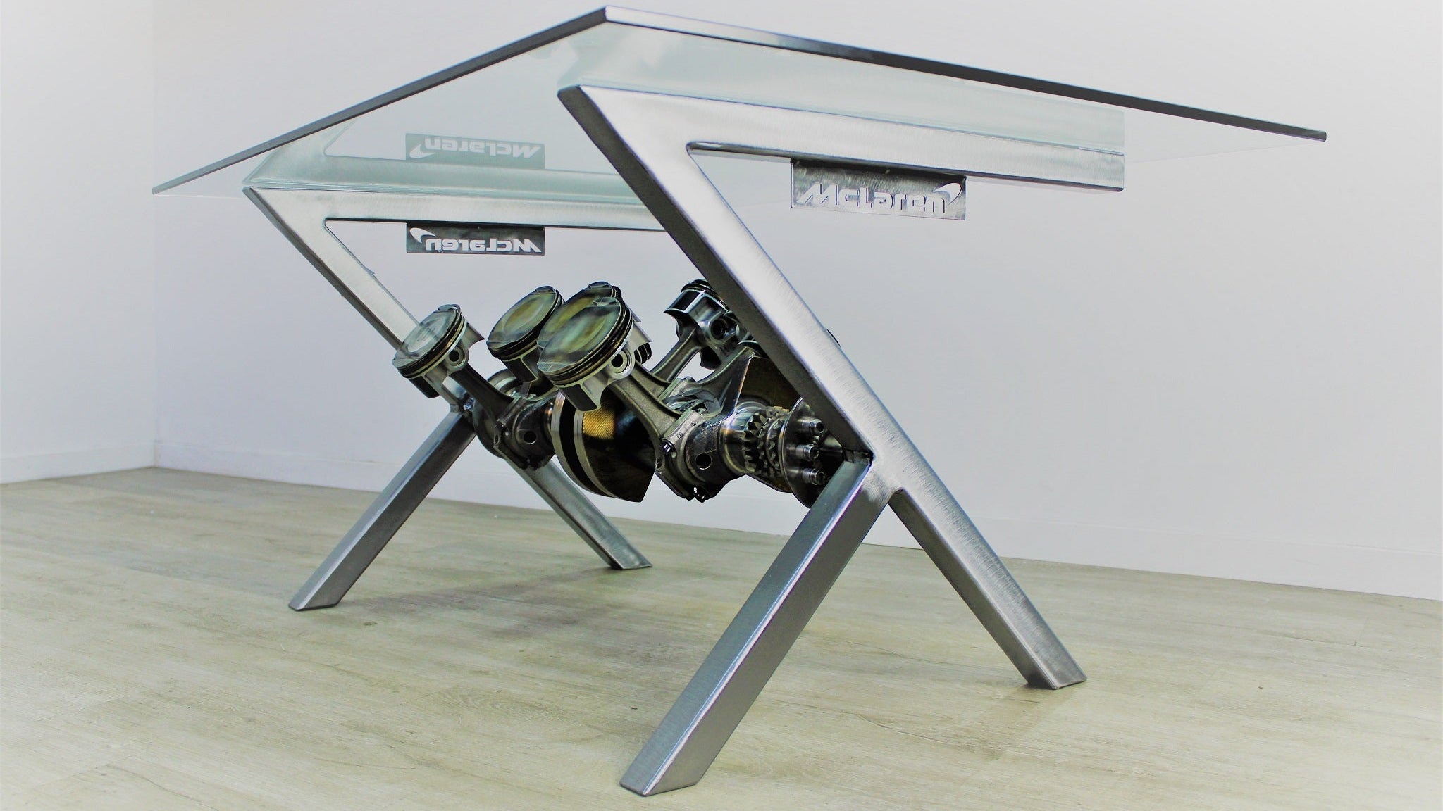 Glass table with car engine design on a wooden floor