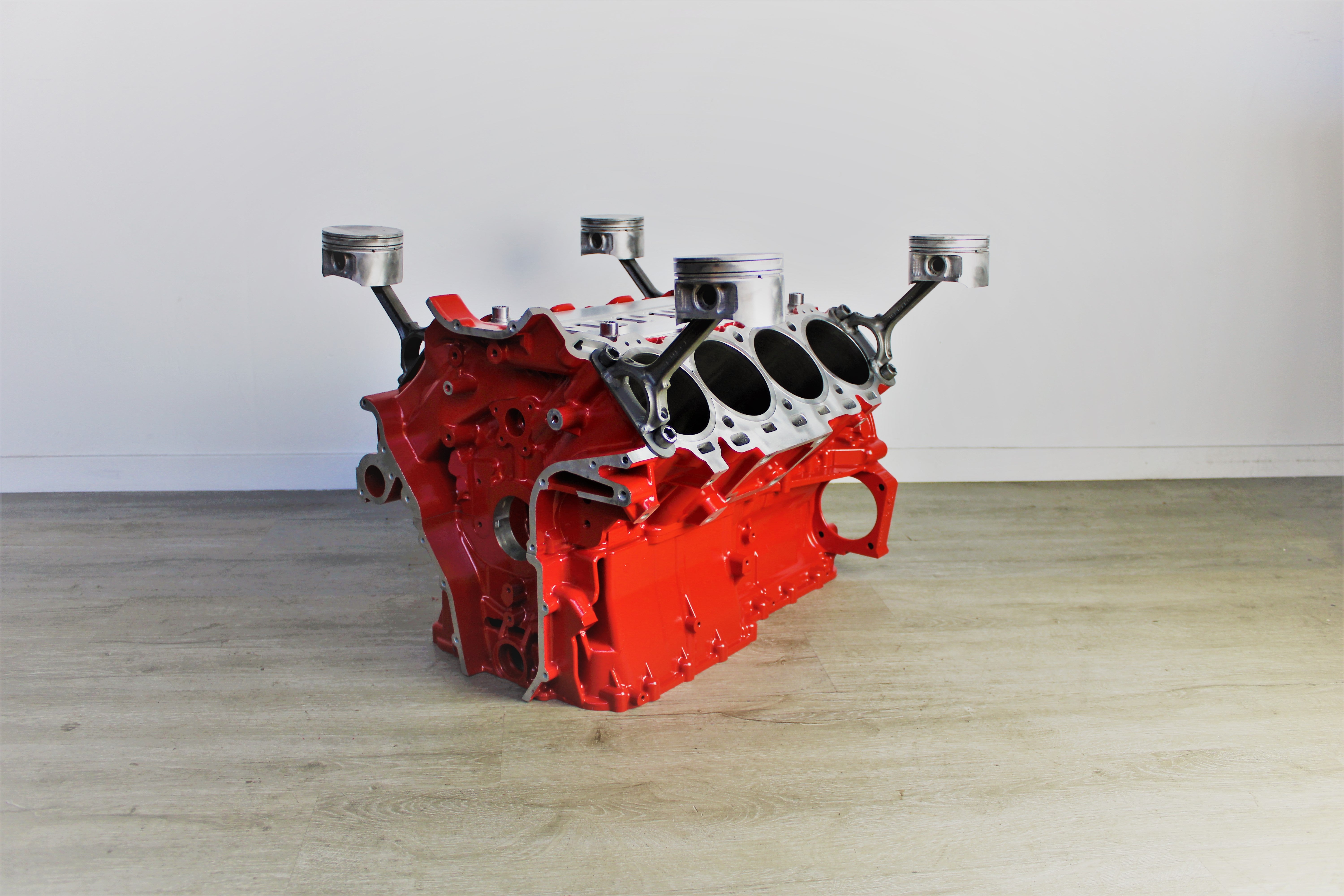 Ferrari engine block coffee table finished in red without its glass top.