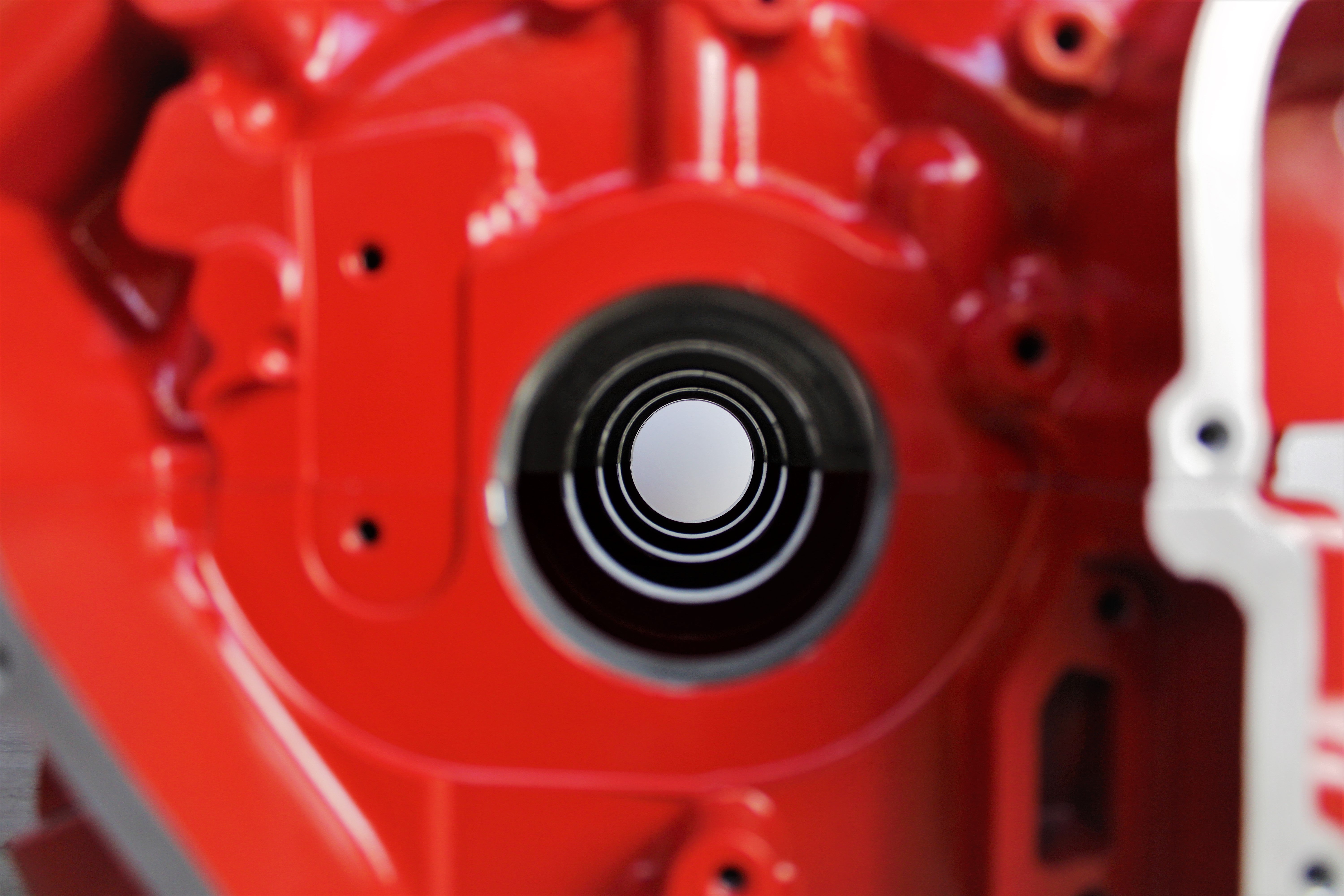 Close-up view of a Ferrari engine block coffee table finished in red.