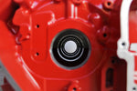 Load image into Gallery viewer, Close-up view of a Ferrari engine block coffee table finished in red.
