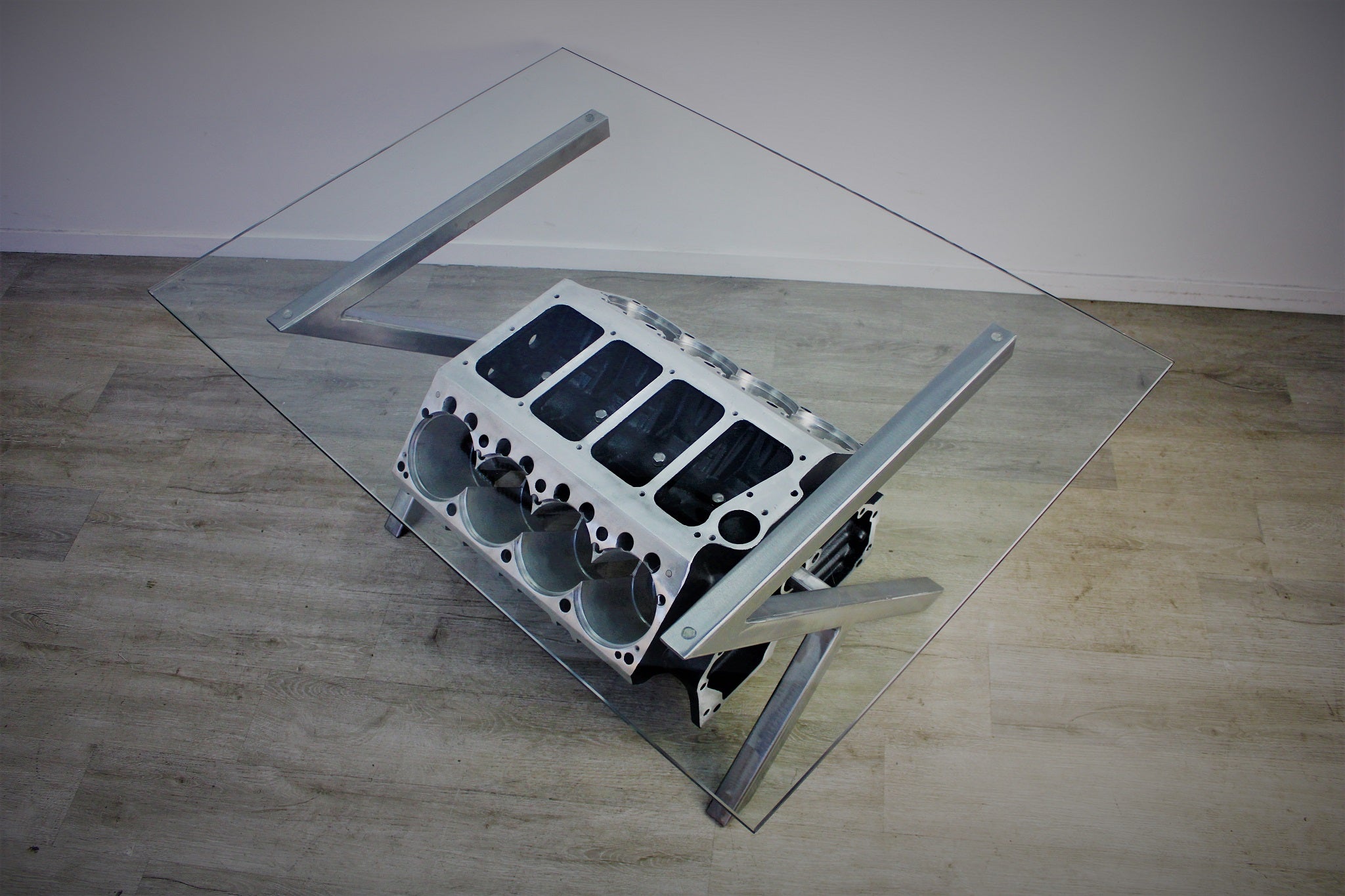 Birds-eye view of a Top Fuel aluminum engine block coffee table finished in black and silver with a rectangular glass top.