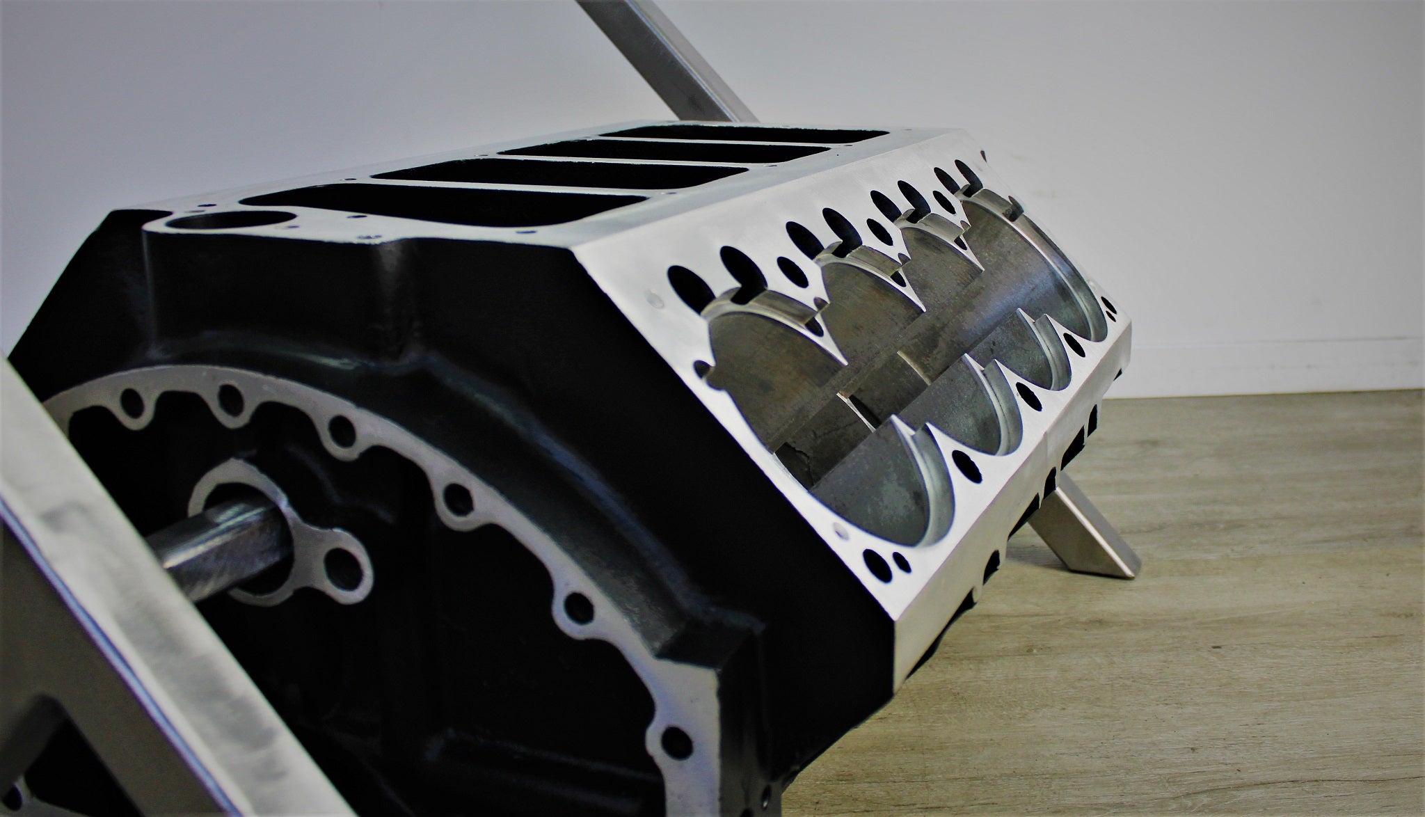 Close-up view of a Top Fuel aluminum engine block coffee table finished in black and silver.