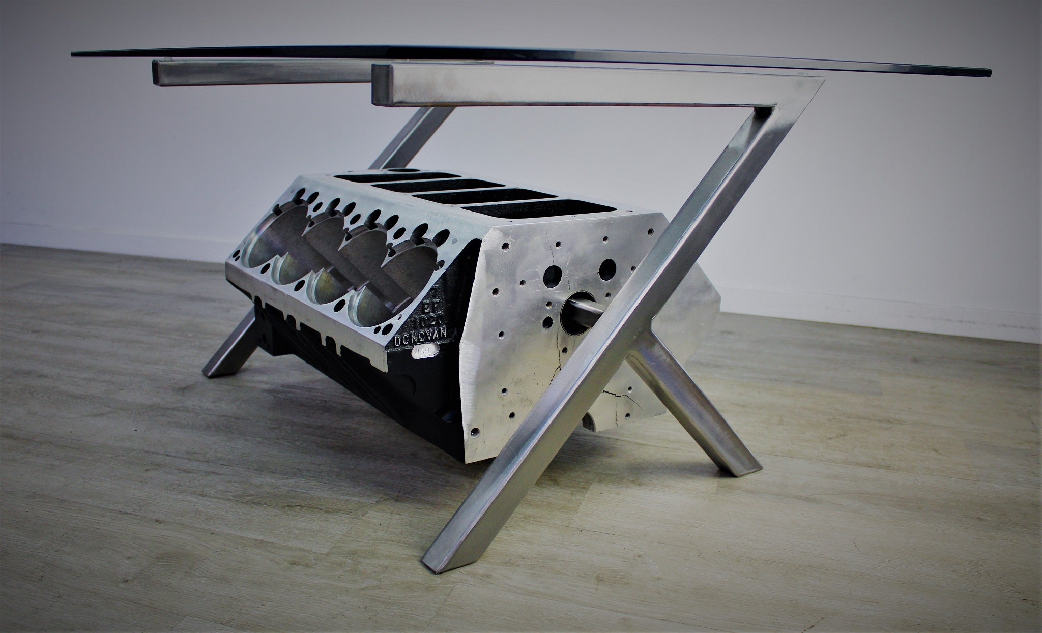 Top Fuel aluminum engine block coffee table finished in black and silver with a rectangular glass top.