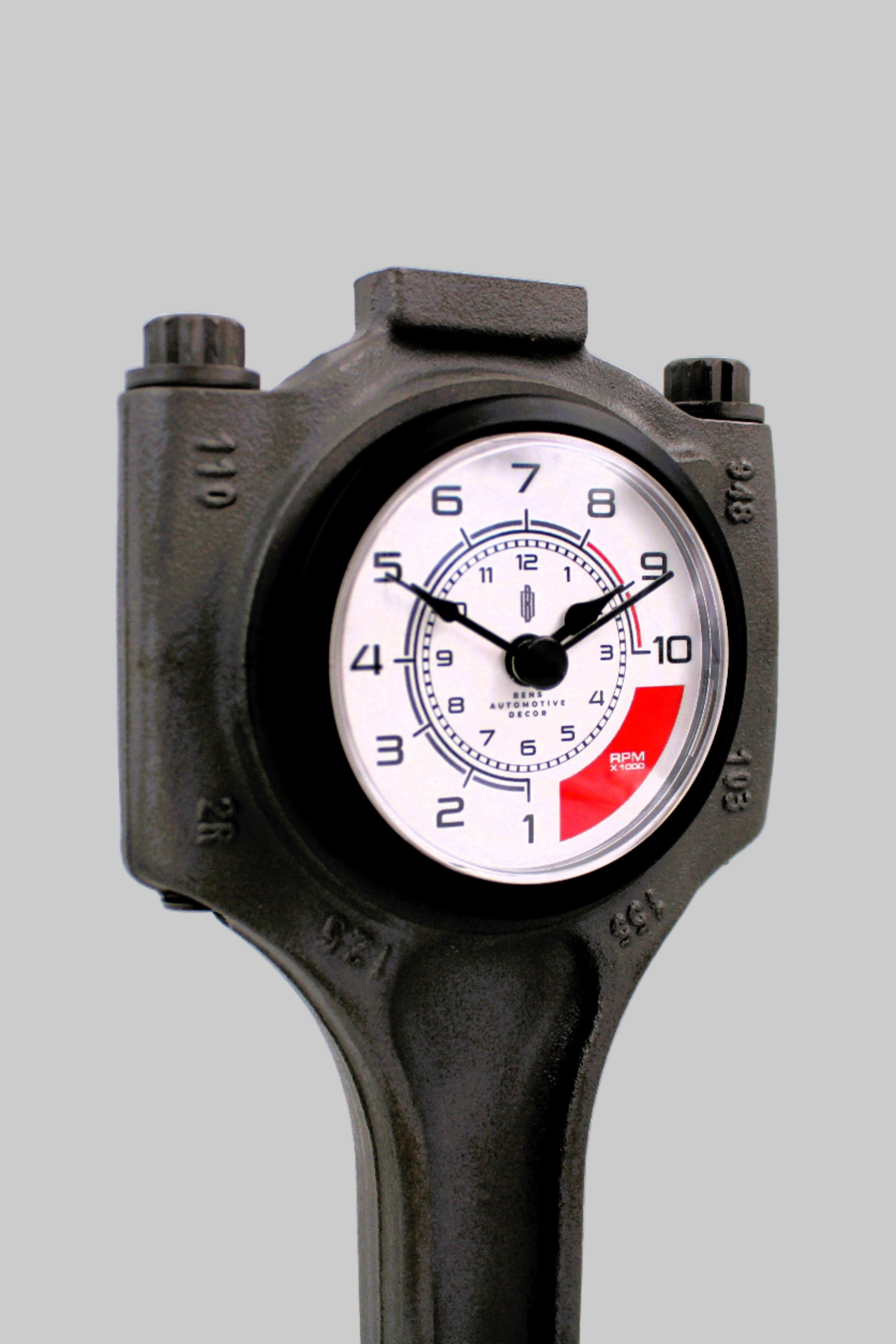 Black tool with a clock face on a white background