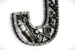 Load image into Gallery viewer, Close-up view of a letter J made out of real car parts, outlined with a timing chain.
