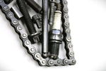 Load image into Gallery viewer, Close-up view of a letter N made out of real car parts, outlined with a timing chain.
